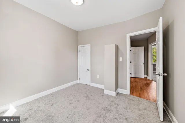 an empty room with closet and door