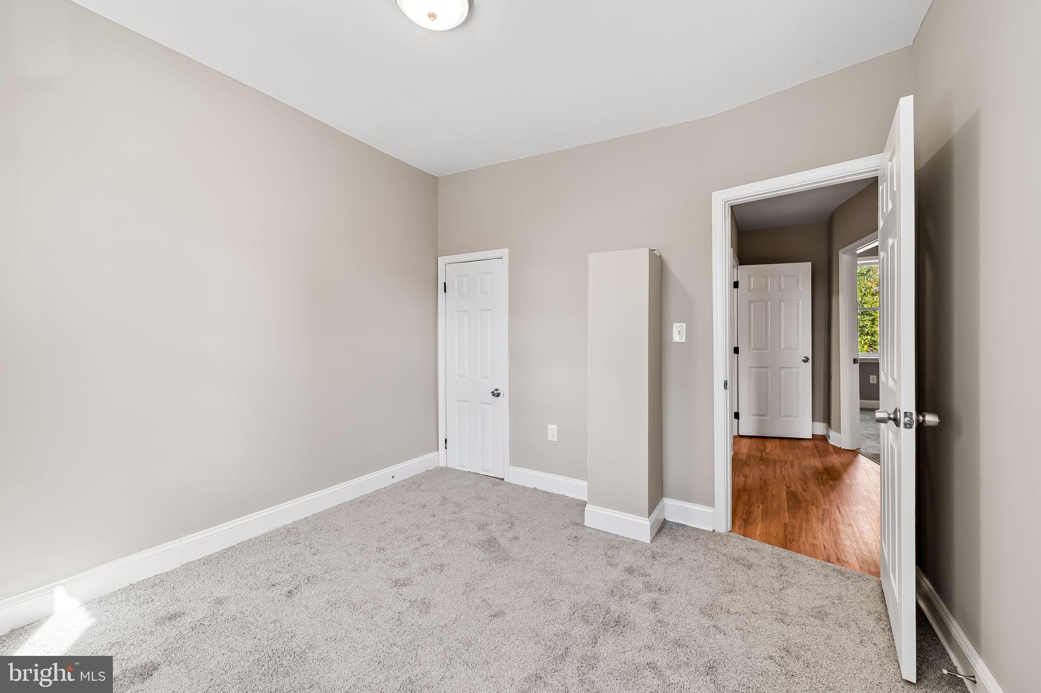 4021 Park Heights Avenue Baltimore, MD 21215 - Photo 17 of 32 an empty room with closet and door