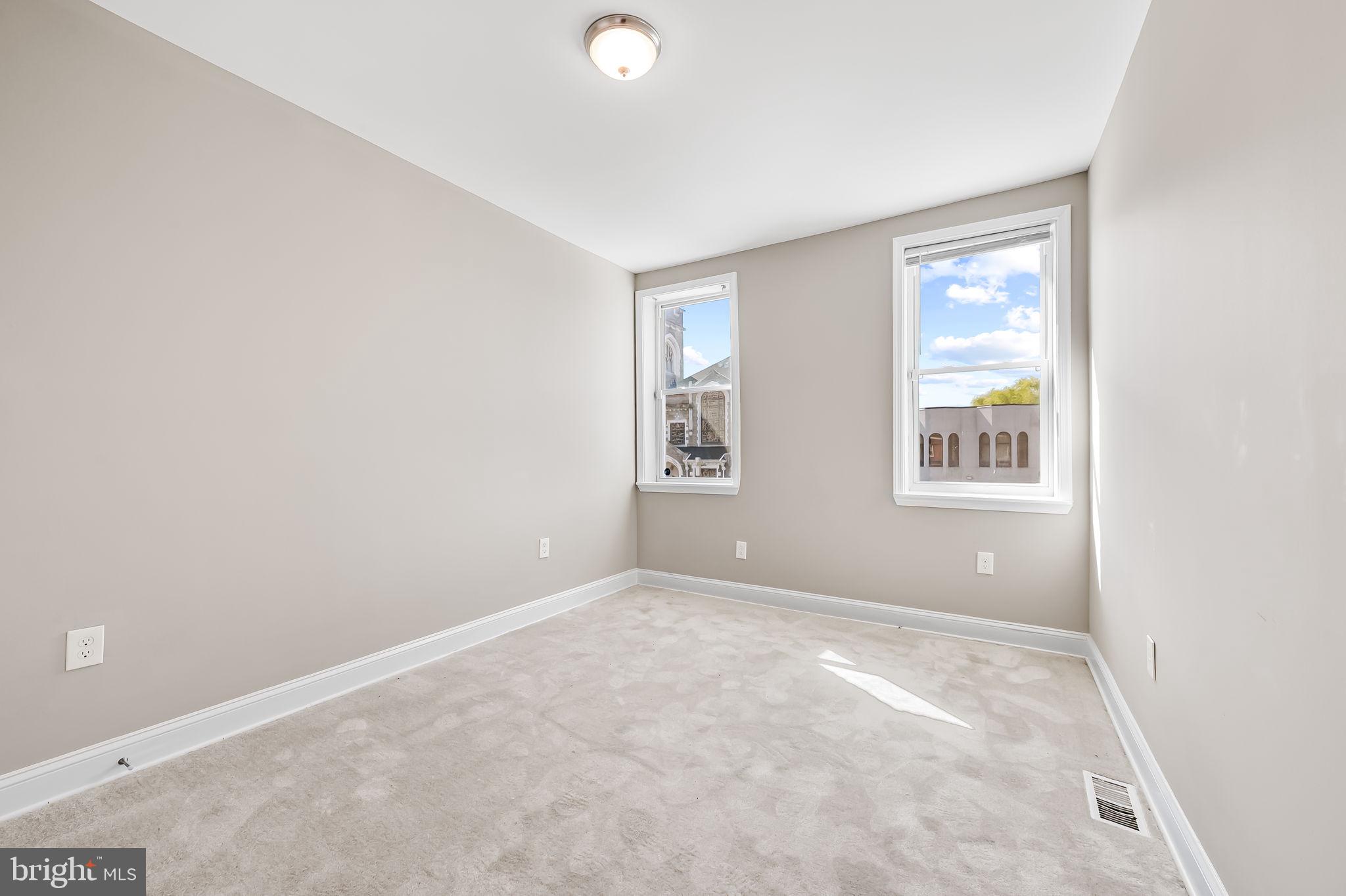 4021 Park Heights Avenue Baltimore, MD 21215 - Photo 18 of 32 an empty room with windows