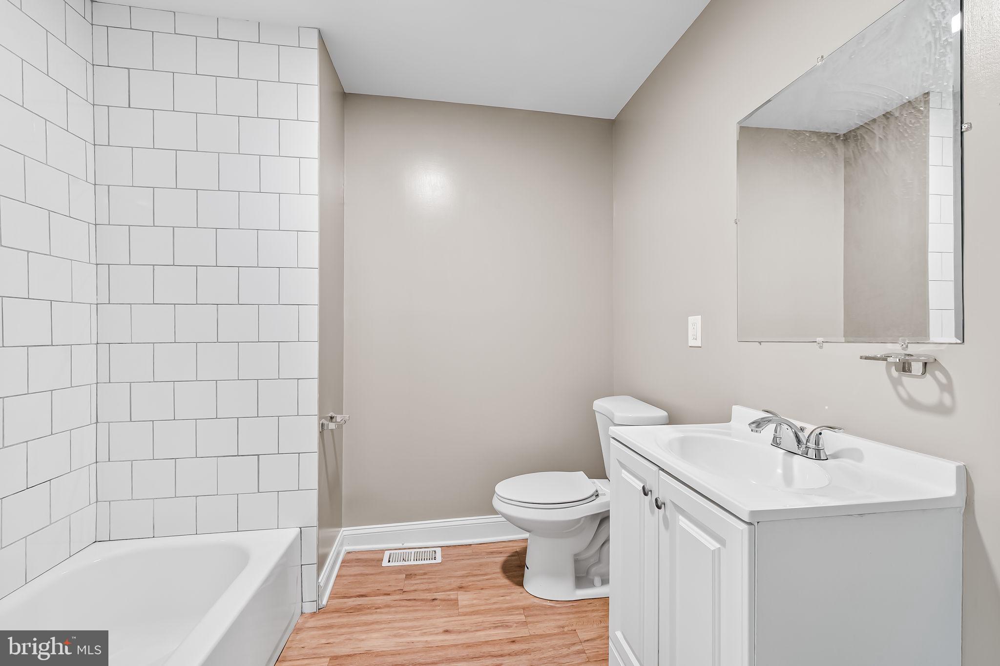 4021 Park Heights Avenue Baltimore, MD 21215 - Photo 20 of 32 a bathroom with a sink and a bathtub