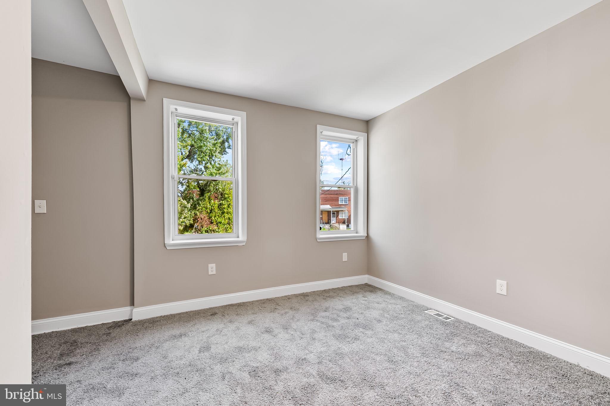 4021 Park Heights Avenue Baltimore, MD 21215 - Photo 21 of 32 an empty room with windows