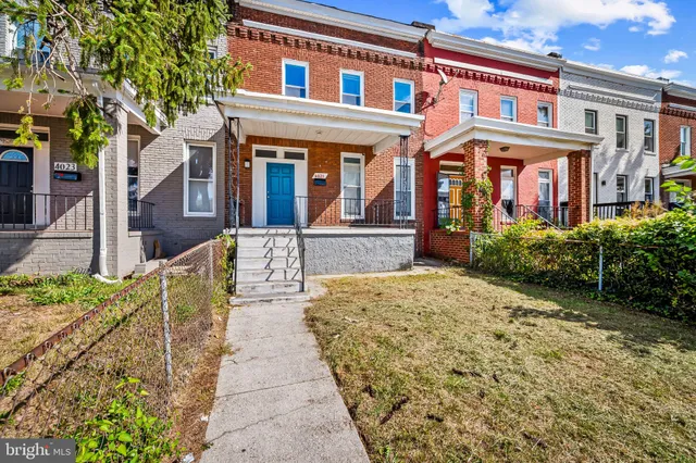 front view of a brick house with a small yard