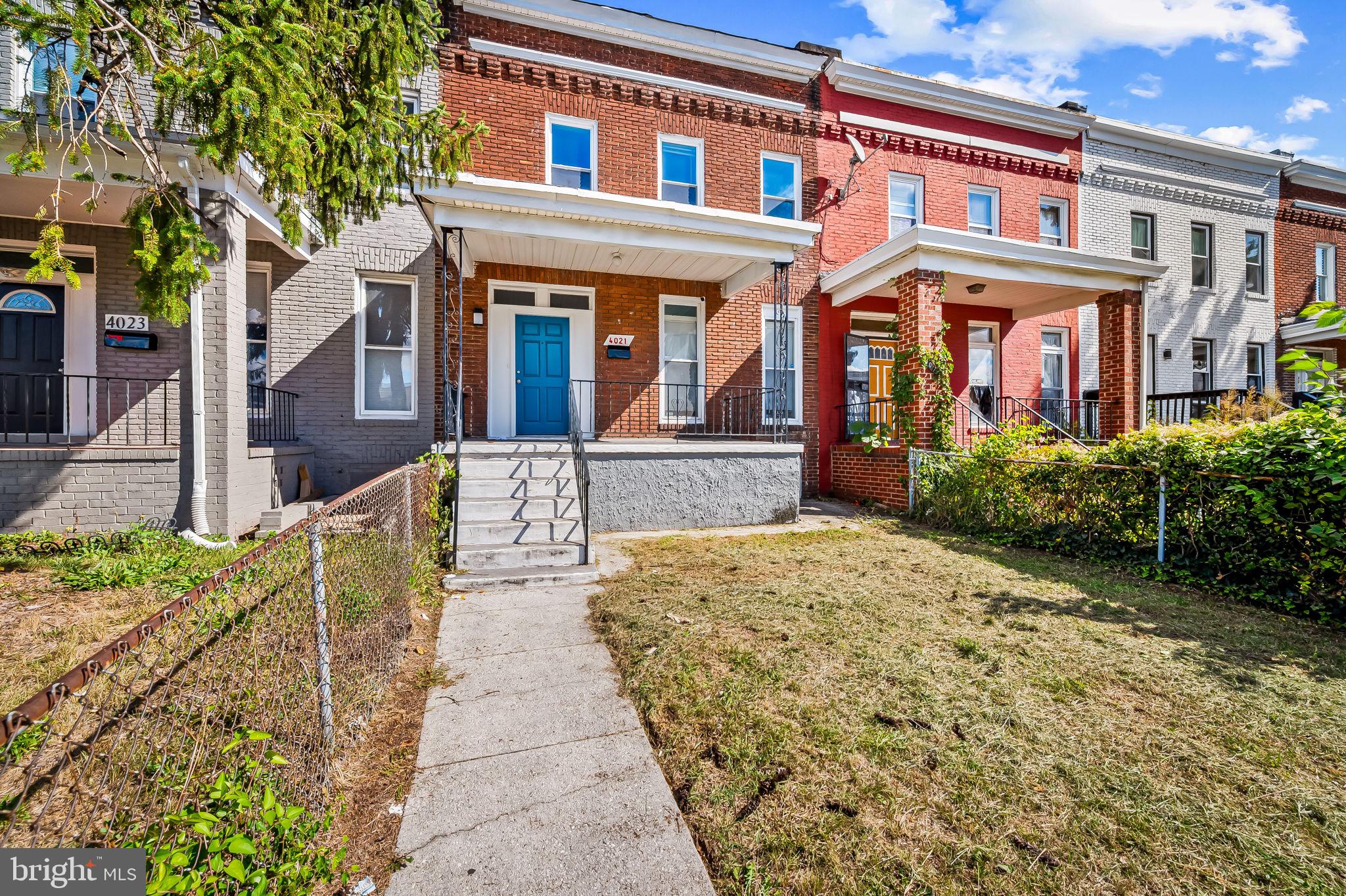 4021 Park Heights Avenue Baltimore, MD 21215 - Photo 31 of 32 front view of a brick house with a small yard