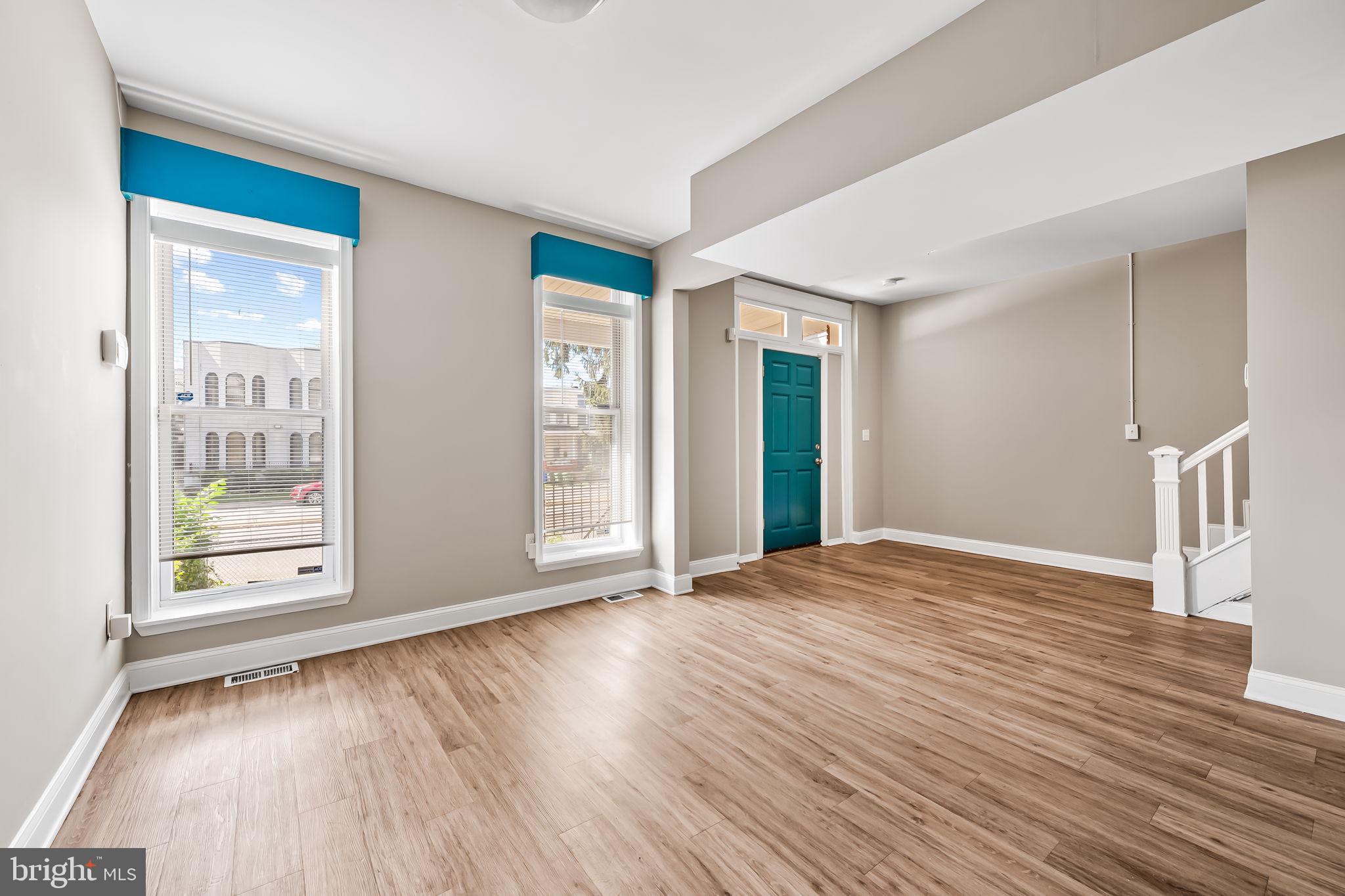 4021 Park Heights Avenue Baltimore, MD 21215 - Photo 5 of 32 a view of an empty room with wooden floor and a window