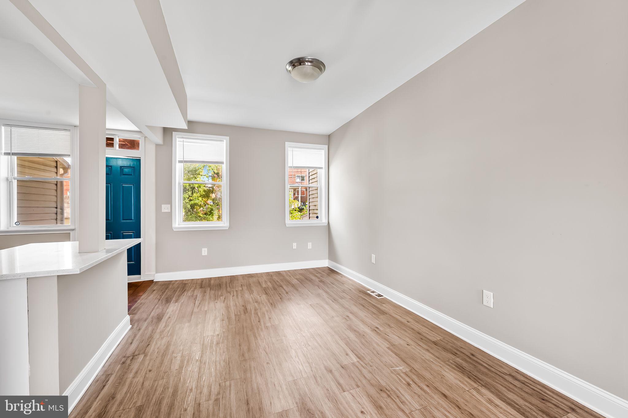 4021 Park Heights Avenue Baltimore, MD 21215 - Photo 8 of 32 wooden floor in an empty room with a window