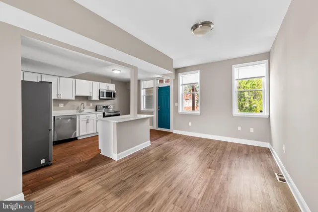 a view of kitchen with wooden floor and electronic appliances