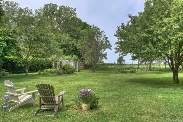 a backyard of a house with table and chairs