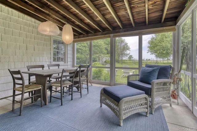 a living room with furniture a wooden floor and a floor to ceiling window