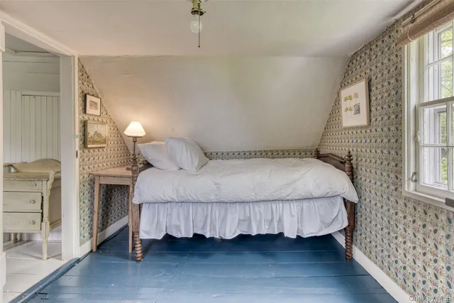 a bedroom with a bed and a fireplace