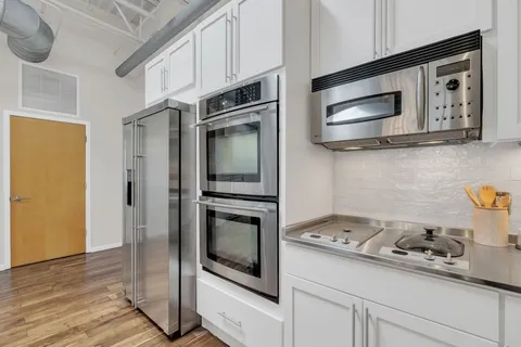 a kitchen with stainless steel appliances a stove a microwave and a refrigerator