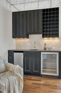 a living room with furniture a fireplace and a large window