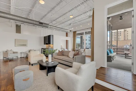 a view of a dining room with furniture and wooden floor