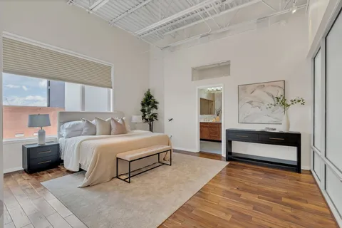 a bedroom with a bed and a potted plant