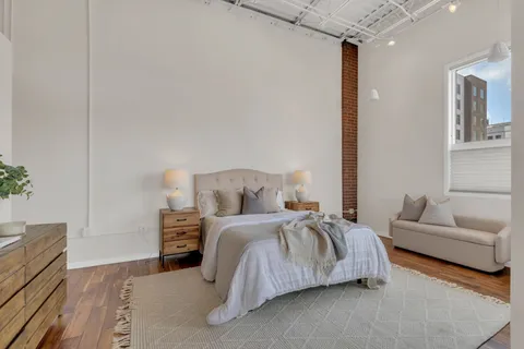 a bedroom that has a bed and a table in it