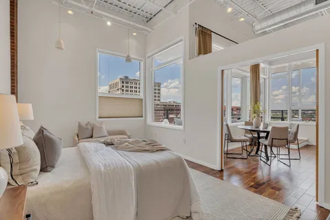 a bedroom with a bed and a painting on the wall