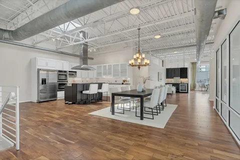 a view of a livingroom with furniture and a kitchen