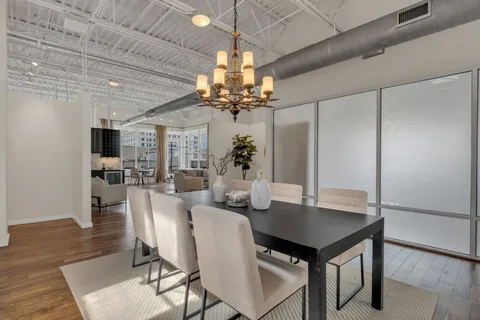 a view of a dining room with furniture and a chandelier
