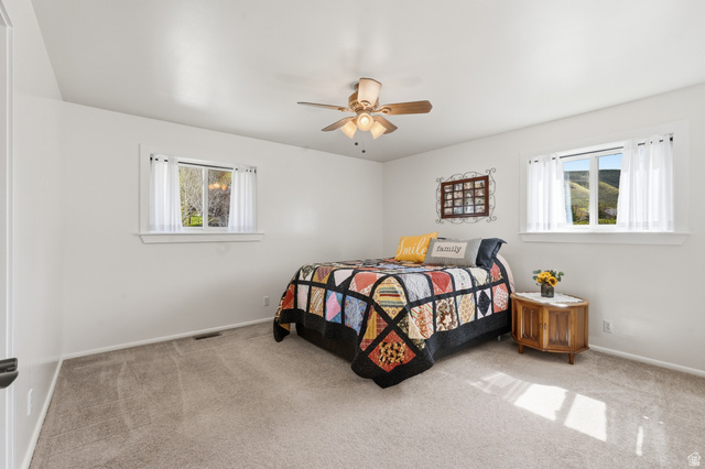 2420 West Old Hwy Road Morgan, UT 84050 - Photo 21 of 54 Carpeted bedroom with multiple windows and ceiling fan