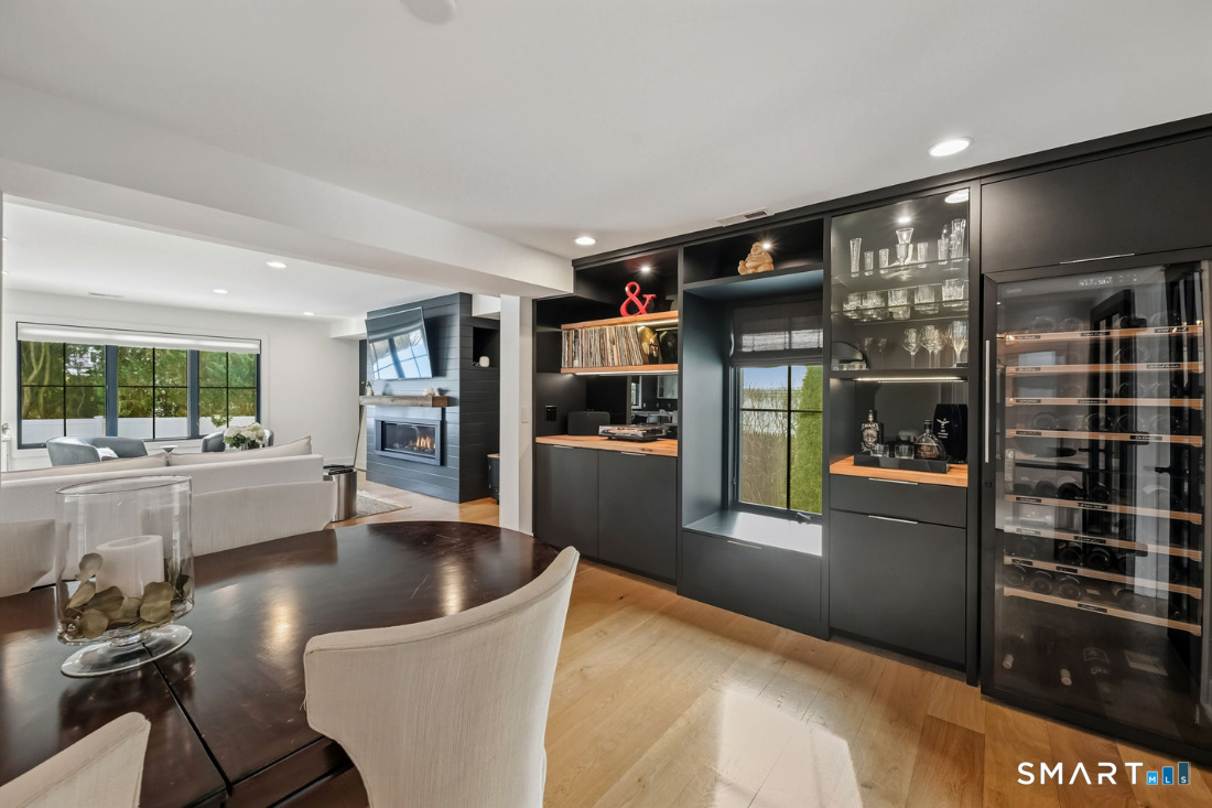 187 Catherine Terrace Fairfield, CT 06824 - Photo 14 of 40 Liquor cabinets with pull outs. 100 year old oak tops from Litchfield adorn built-in cabinetry and bar with window seat, Eurocave and music center.