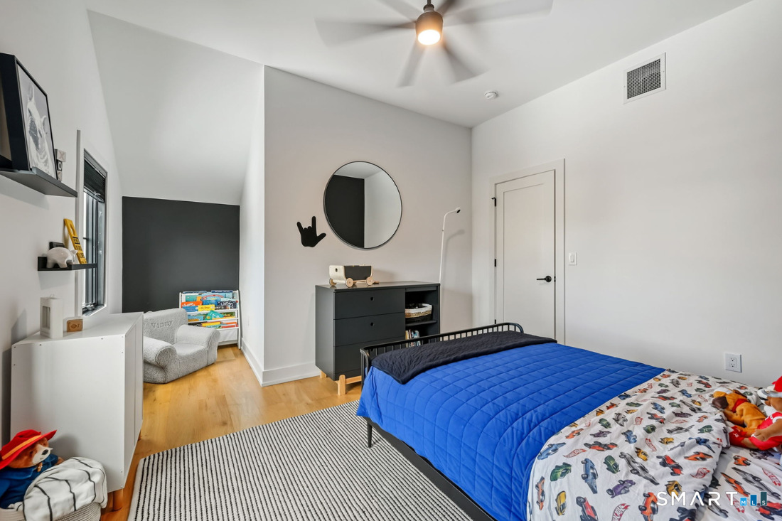 187 Catherine Terrace Fairfield, CT 06824 - Photo 28 of 40 High ceilings, oak flooring, Charcoal painted focal wall and alcove, modern ceiling fan light and walk in closet.