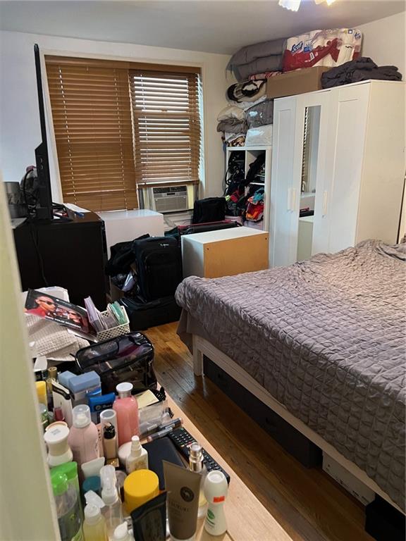 2400 East 3rd Street, Unit 529 Brooklyn, NY 11223 - Photo 4 of 7 a bedroom with a bed gym equipment and a large window