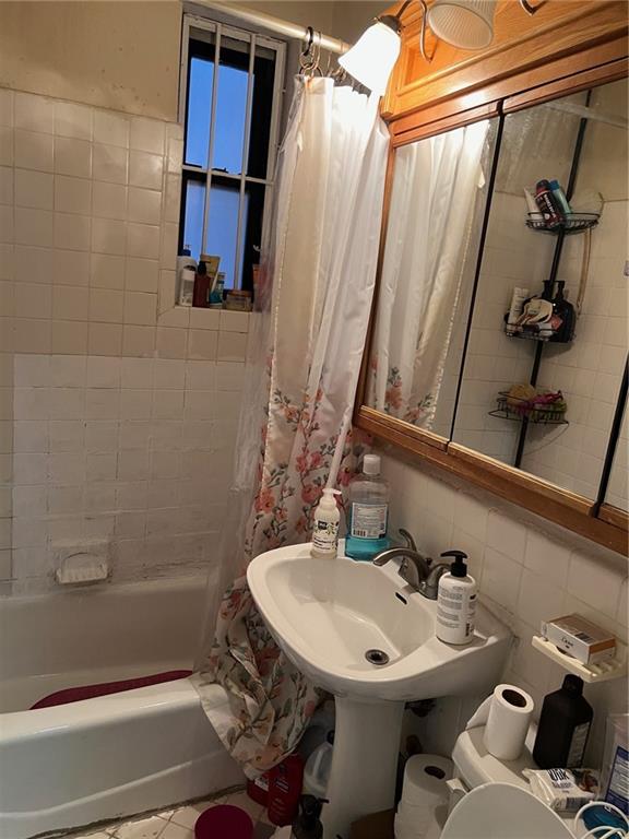2400 East 3rd Street, Unit 529 Brooklyn, NY 11223 - Photo 5 of 7 a bathroom with a sink a toilet and shower