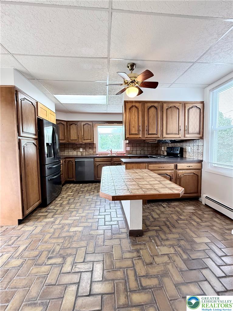 5540 Main Street Whitehall, PA 18052 - Photo 7 of 53 A functional kitchen features a practical central island and ample cabinetry, offering a comfortable space for everyday meal preparation.