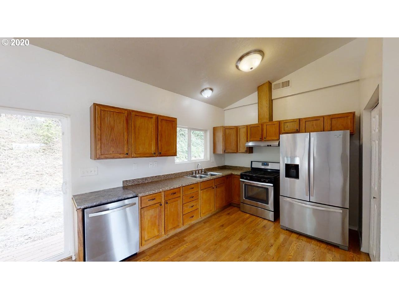 340 Kalapuya Way Cottage Grove, OR 97424 - Photo 8 of 20 a kitchen with stainless steel appliances a refrigerator and a sink