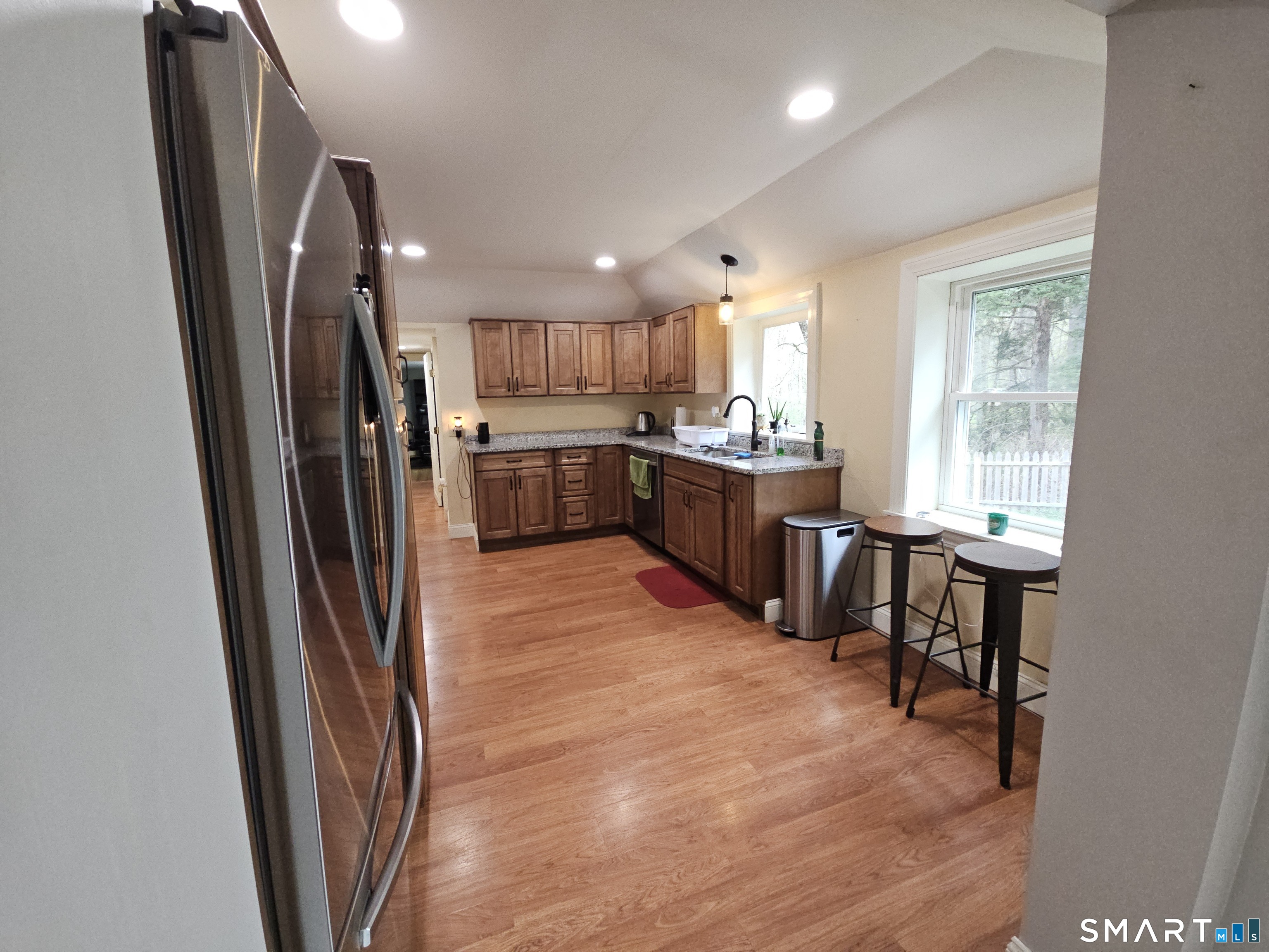 4 Breaults Landing Road Thompson, CT 06277 - Photo 11 of 39 a kitchen with stainless steel appliances granite countertop a refrigerator a sink dishwasher a stove a dining table and chairs with wooden floor