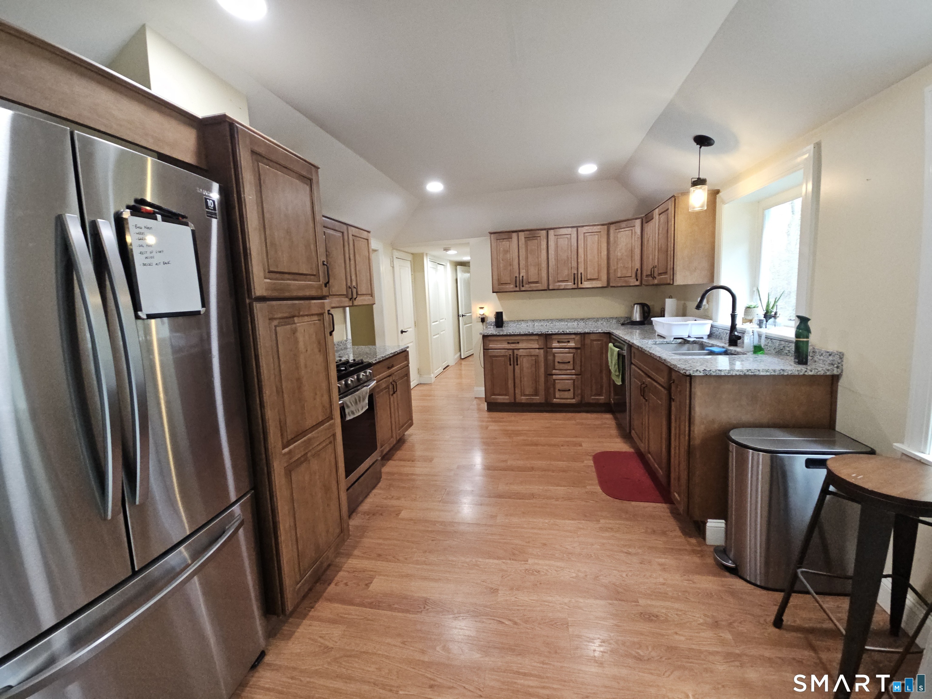 4 Breaults Landing Road Thompson, CT 06277 - Photo 12 of 39 a kitchen with refrigerator a sink a stove and chairs