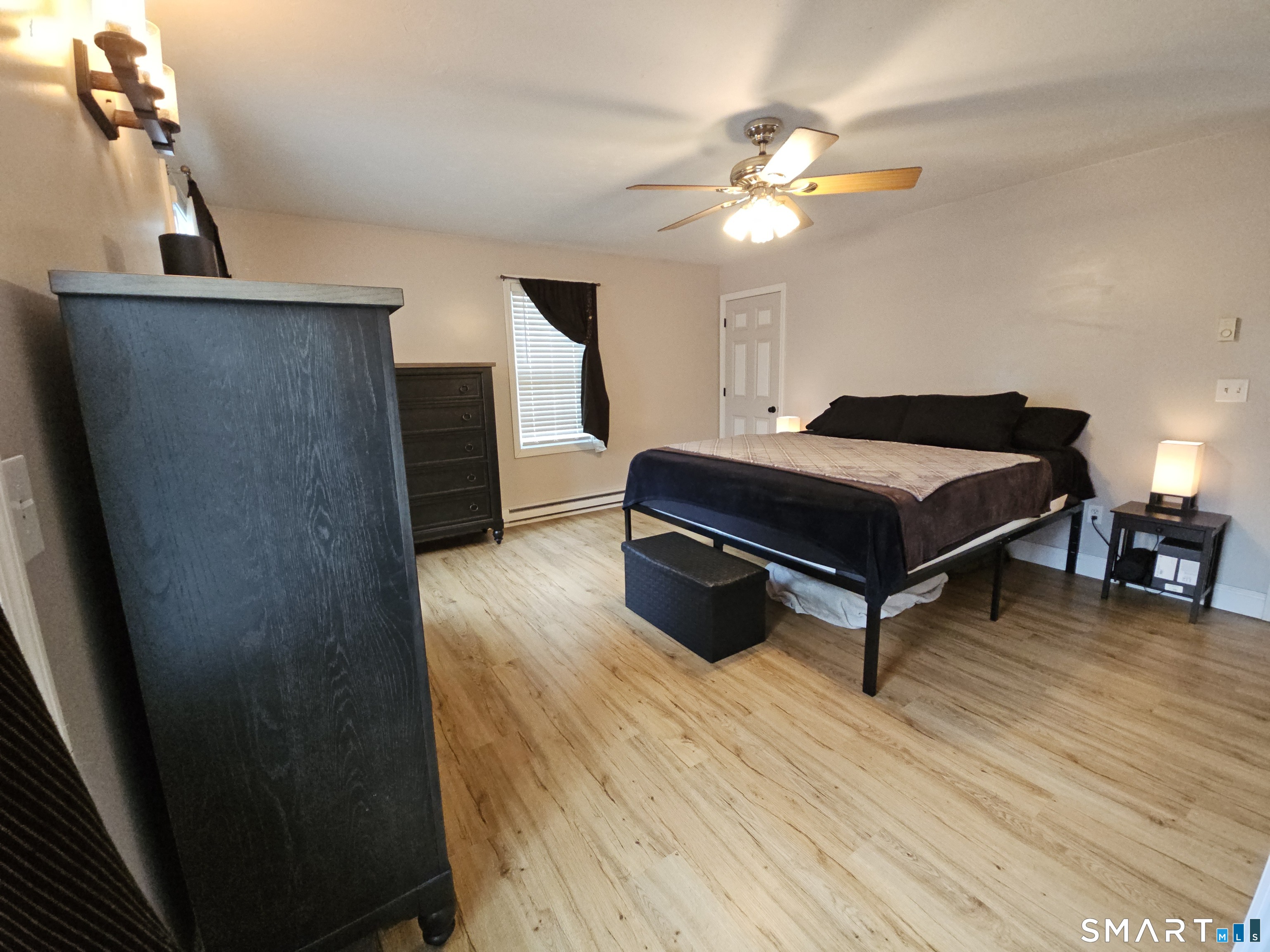 4 Breaults Landing Road Thompson, CT 06277 - Photo 15 of 39 a living room with a bed furniture and a chandelier