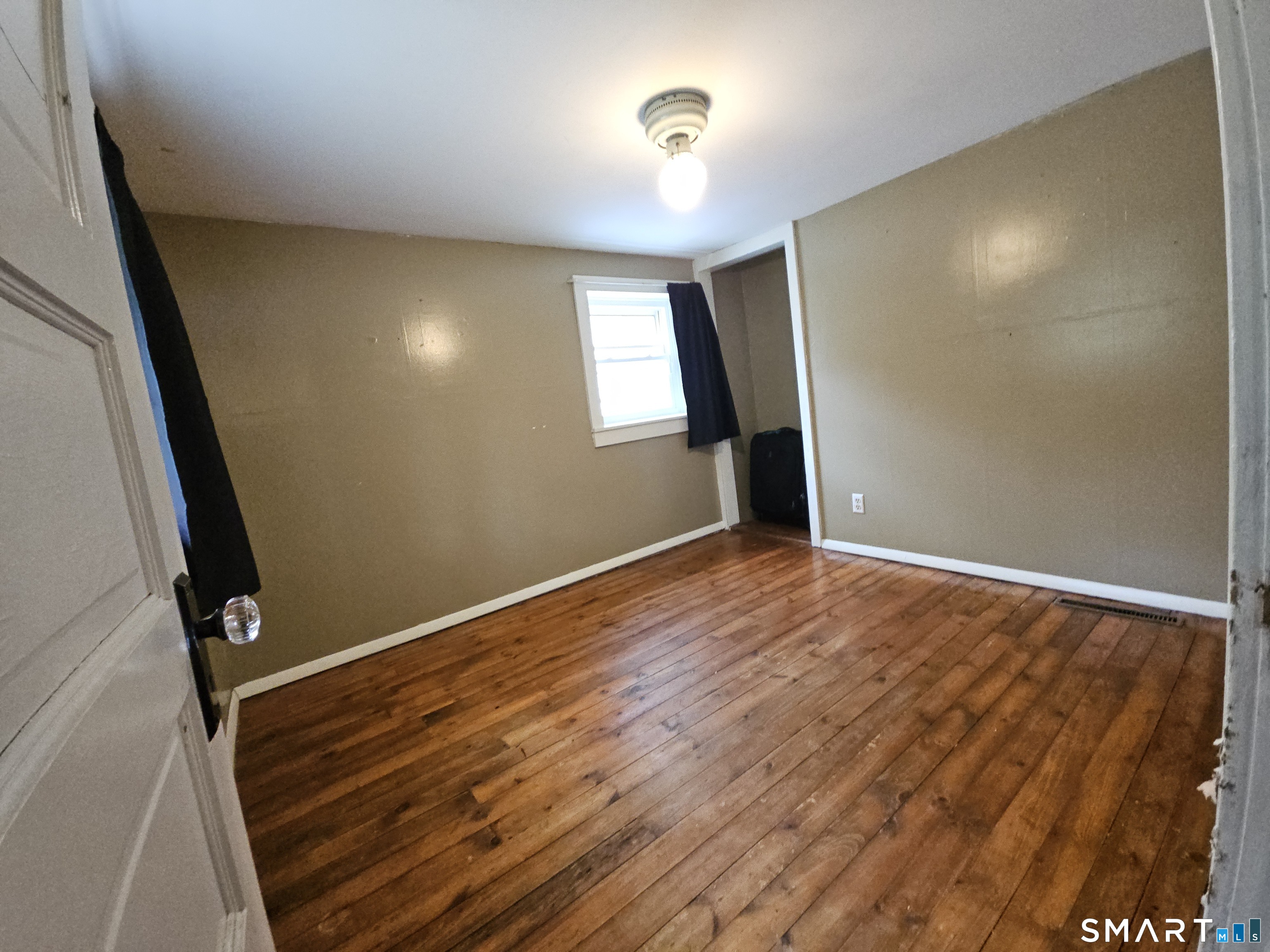 4 Breaults Landing Road Thompson, CT 06277 - Photo 23 of 39 an empty room with wooden floor and windows