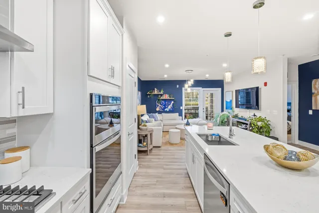 a large kitchen with stainless steel appliances lots of counter space and a window