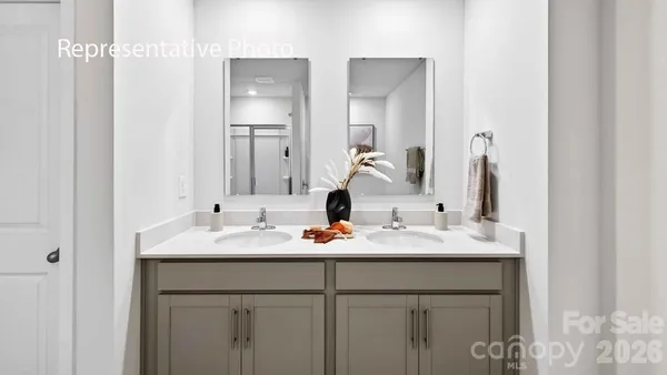 a bathroom with double sink and a mirror