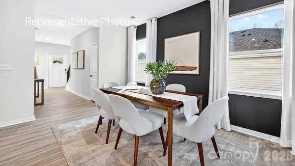 a dining room with furniture and wooden floor