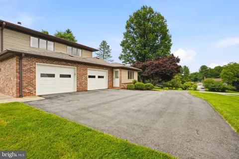 a view of a house with a yard and garage