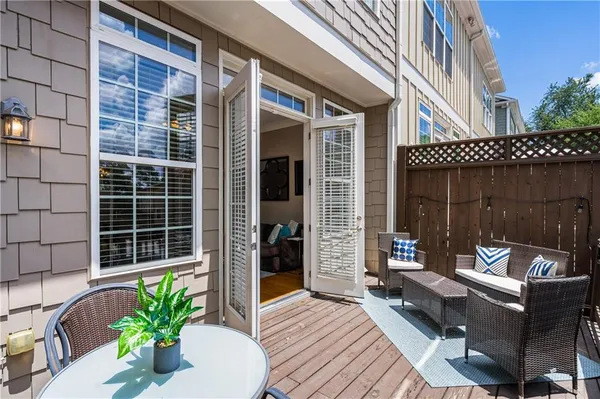 a view of a balcony with chairs and a potted plant