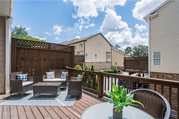 a view of a patio with couches table and chairs and potted plants