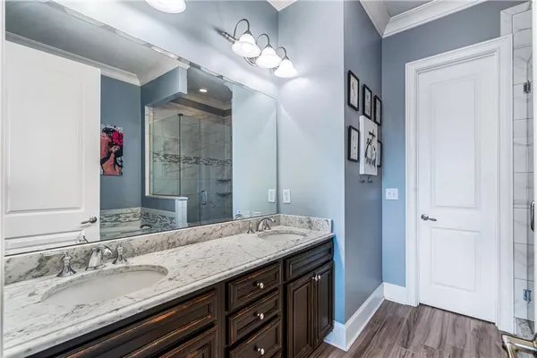 a bathroom with a granite countertop sink a vanity and a large mirror