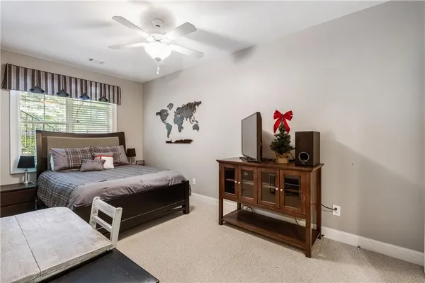 a bedroom with a bed and a chandelier