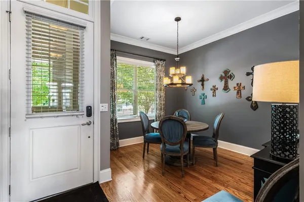 a view of a dining room with furniture window and wooden floor