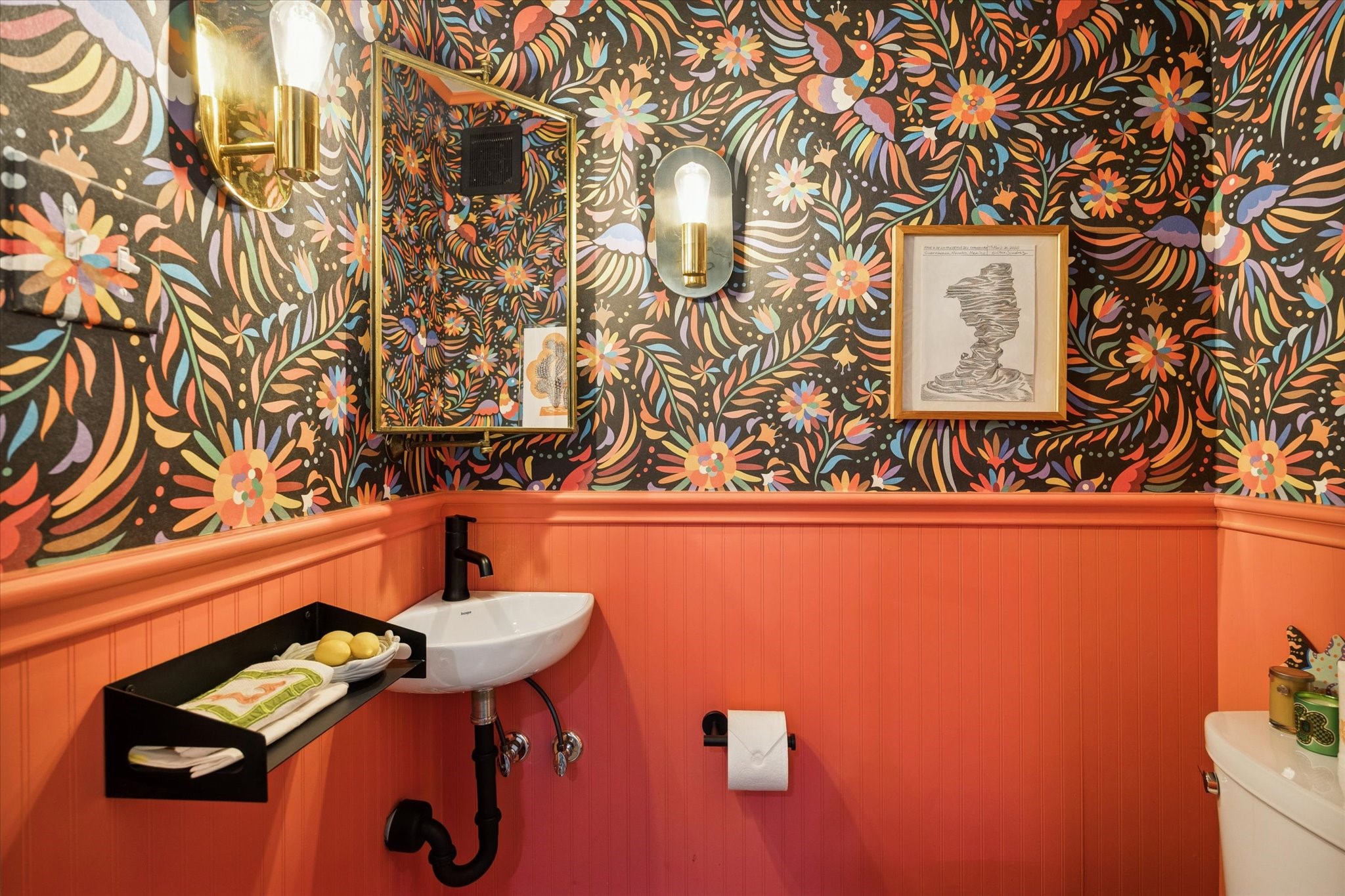 2109 Colquitt Street Houston, TX 77098 - Photo 15 of 28 The stylish powder bath makes a statement with bold wallpaper, designer lighting, and a wall-mounted sink.