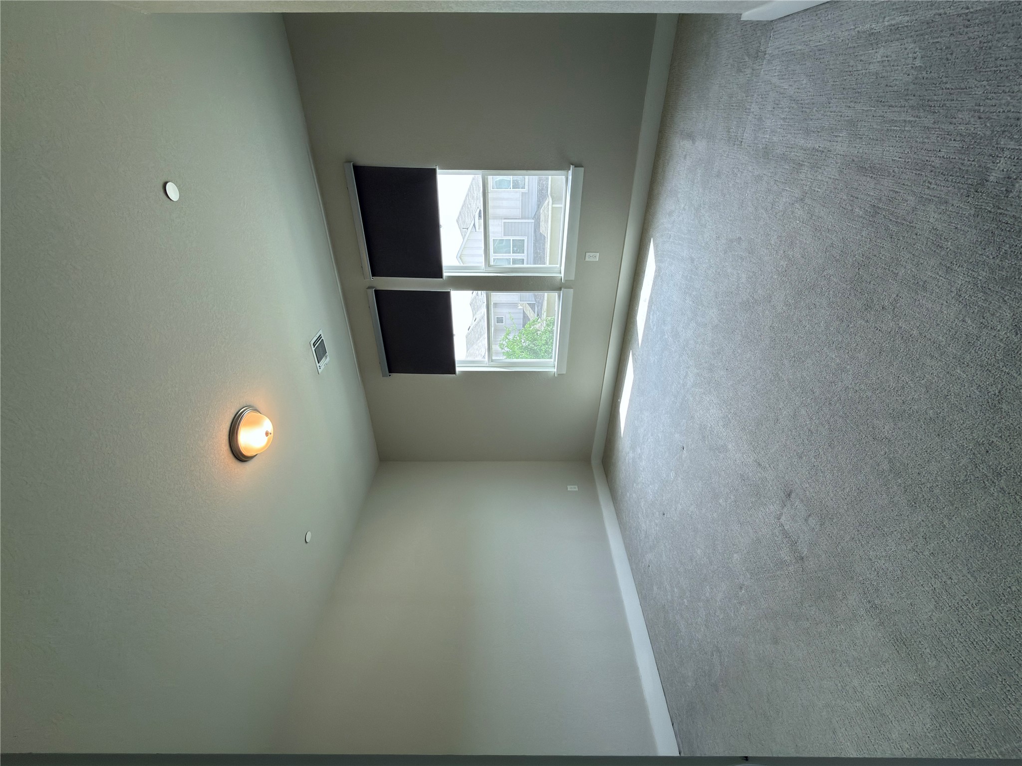 11216 Gadsen Lane Austin, TX 78754 - Photo 27 of 36 A well-lit bedroom featuring light carpeting and two sun-filled windows.
