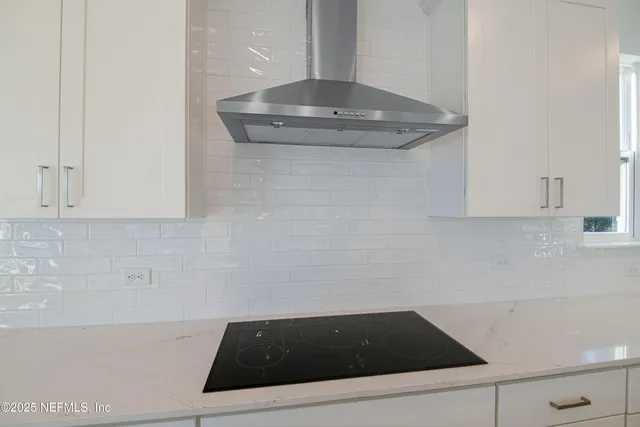a view of a room with window wooden floor and front door