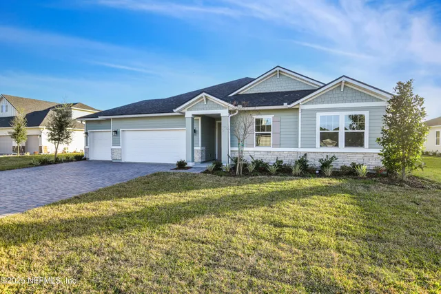 a view of a house with a yard and plants