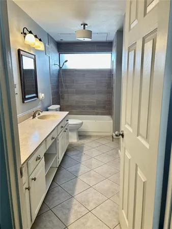 a bathroom with a double vanity sink a mirror and a bathtub