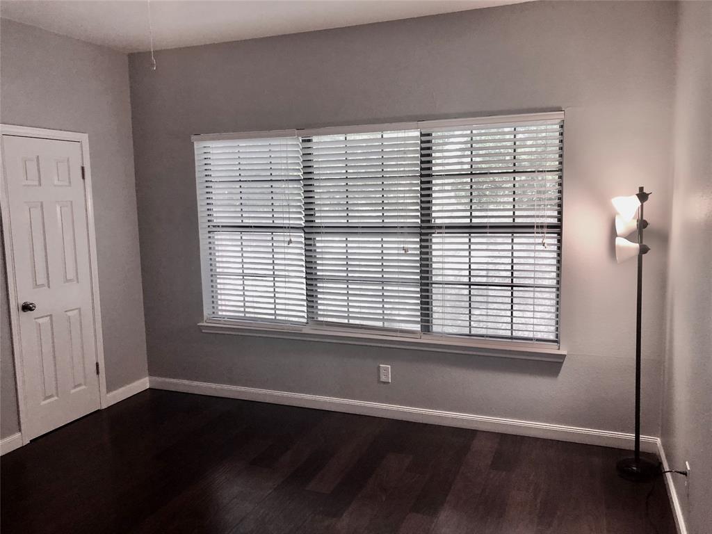 5859 Frankford Road, Unit 803 Dallas, TX 75252 - Photo 16 of 21 a view of an empty room with wooden floor and a window