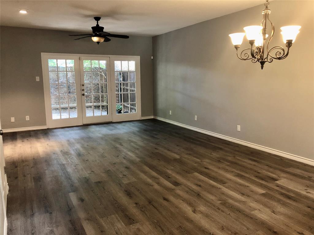5859 Frankford Road, Unit 803 Dallas, TX 75252 - Photo 8 of 21 a view of an empty room with wooden floor and a window