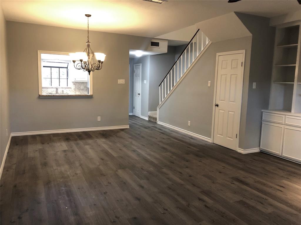 5859 Frankford Road, Unit 803 Dallas, TX 75252 - Photo 9 of 21 an empty room with wooden floor and windows