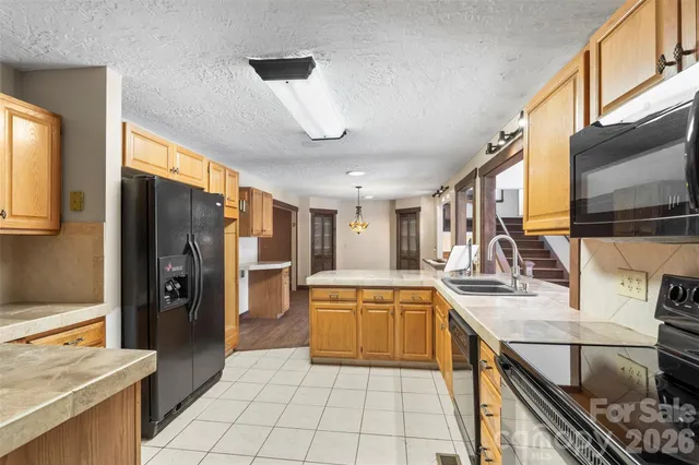 a view of a hallway with wooden floor and entryway